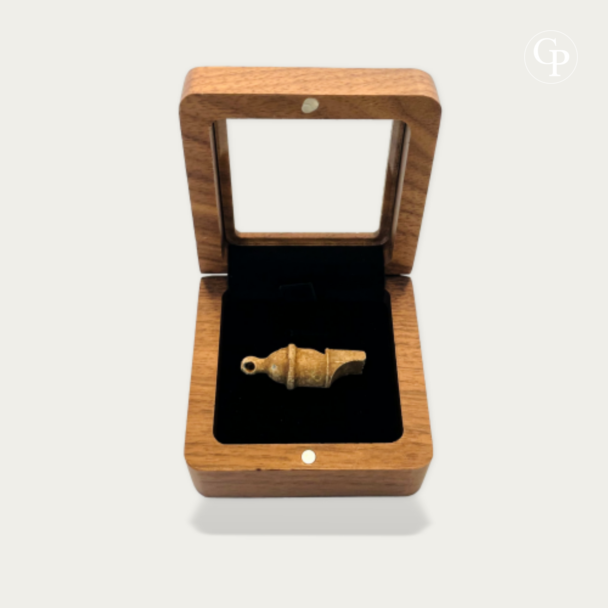 Ancient Roman legionary lead whistle displayed in an open wood effect box with black velvet interior | Sifflet antique en plomb de légionnaire romain présenté dans une boîte en imitation bois ouverte avec intérieur en velours noir