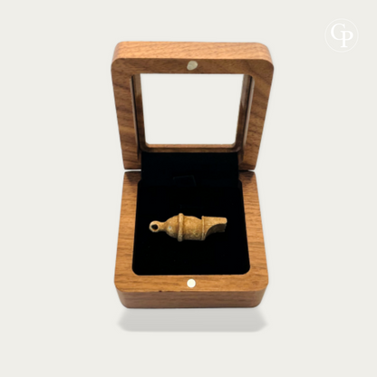 Ancient Roman legionary lead whistle displayed in an open wood effect box with black velvet interior | Sifflet antique en plomb de légionnaire romain présenté dans une boîte en imitation bois ouverte avec intérieur en velours noir