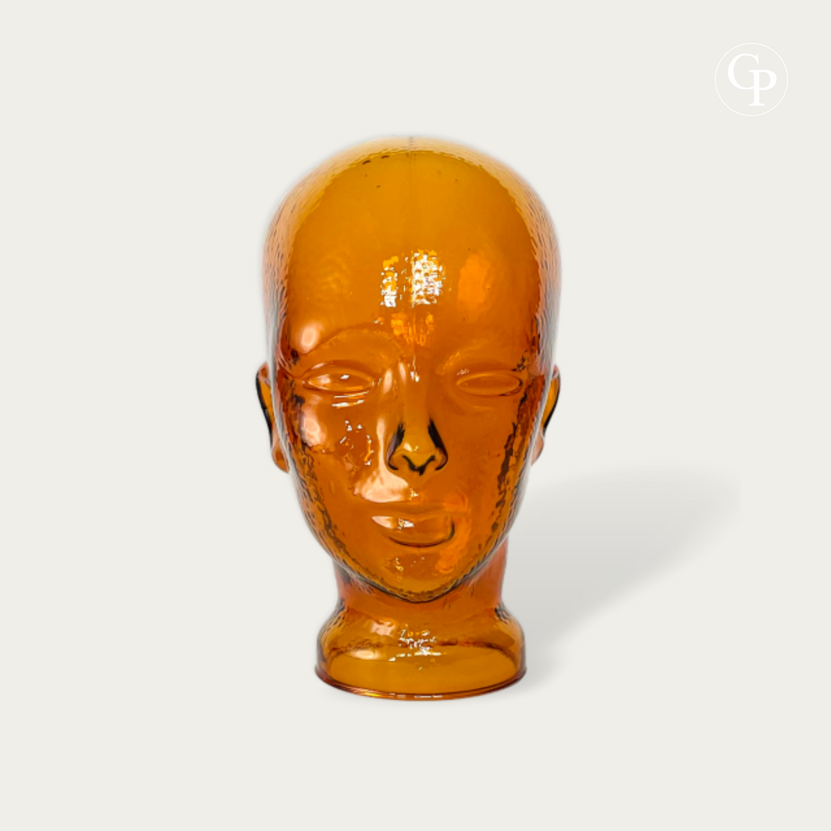 Tête mannequin vintage en verre moulé ambre cognac style Space Age 1970 vue de face sur fond neutre | Vintage 1970s Space Age amber cognac molded glass mannequin head front view isolated on neutral background