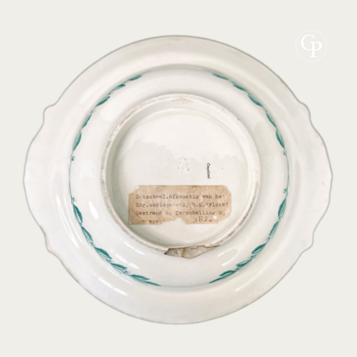 Back view of the Copeland Ironstone serving dish showing the original Dutch label mentioning the shipwreck of HMS Flora at Terschelling and the small period chip on the foot rim.